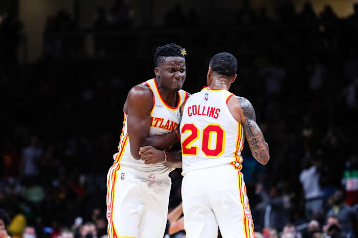 Clint Capela chest bumps John Collins.